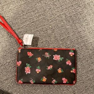 Unused black floral Coach wristlet